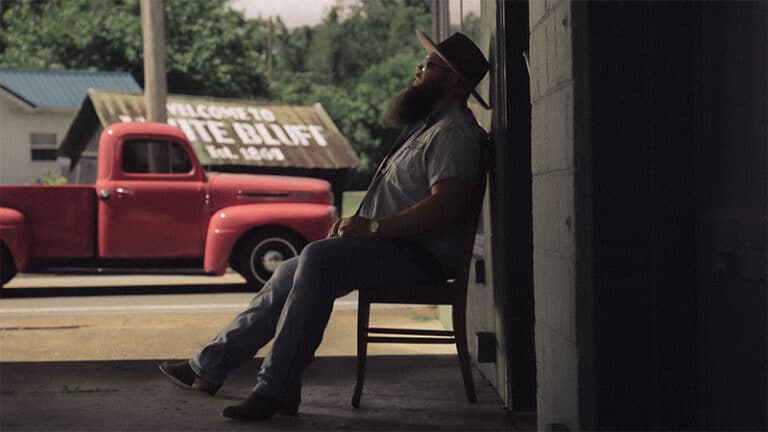 Larry Fleet relaxes on the porch of his lifelong barber shop in his hometown of White Bluff, TN